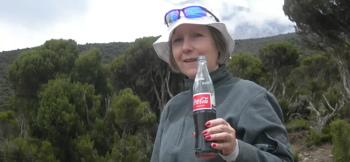 Drinking Coca-Cola along Marangu Route on Kilimanjaro