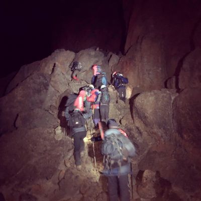 Why do people climb Mount Kilimanjaro at night?