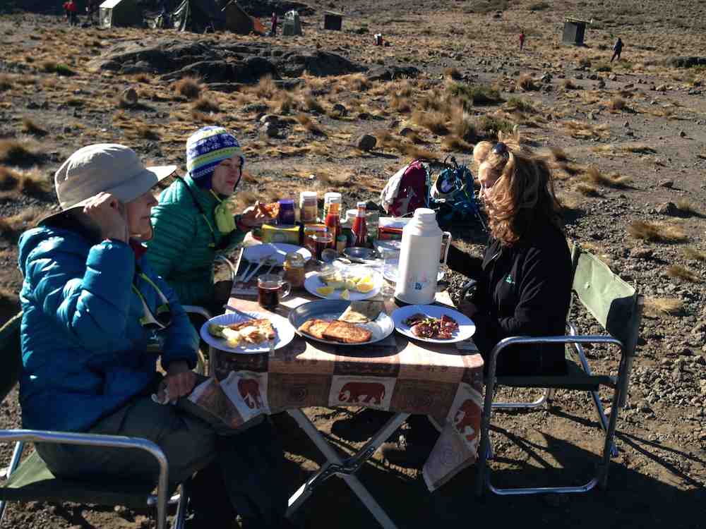 Drinking coffee for breakfast on Mount Kilimanjaro